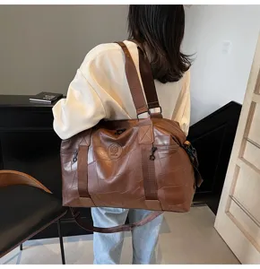 Large capacity brown patchwork travel duffel bag for men and women, stylish and portable.