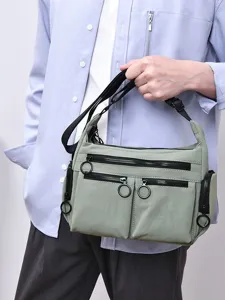Multi-pocket commuter crossbody bag with functional zippers, minimalist casual design for daily use.