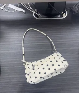 Nylon polka dot underarm bag detail, multi-pocket design, casual white shoulder bag view.