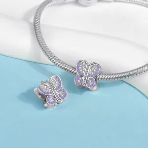 Detailed view of silver snake chain bracelet with purple pavé butterfly charm accessory.