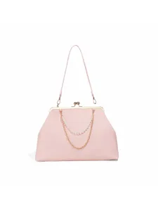 Pink kisslock handbag detail showing pearl chain strap and gold hardware finish elegant design.
