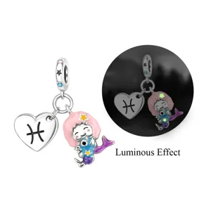 Close-up detail of the luminous Pisces mermaid charm pendant showing glowing night effect.