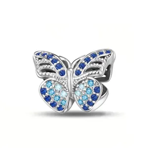 Silver butterfly charm detail showcasing exquisite pave blue crystal stones and intricate wing cutout.
