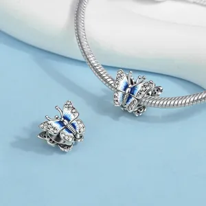 Silver snake chain bracelet and blue enamel butterfly charm bead detail view, cubic zirconia.
