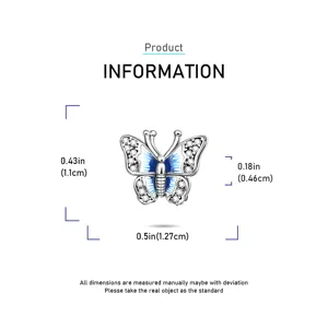 Silver butterfly charm detail view with blue enamel and sparkling zirconia stones inlay.