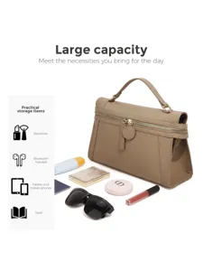 Detail shot of stylish khaki top-handle handbag with large capacity and daily essentials.