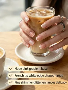 French press-on nails detail closeup showing nude pink gradient and white tips with fine glitter sparkle