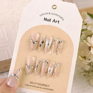 Long coffin press-on nails with soft light butterfly and rhinestones, elegant nude nail art set.