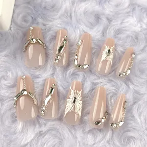 Close-up detail of long coffin press-on nails with silver butterfly and rhinestone decor.