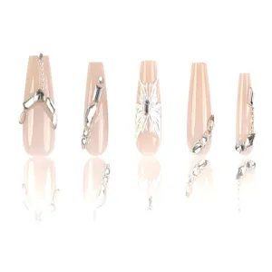 Detailed shot of long trapezoid press-on nails with silver butterfly charms and rhinestones.