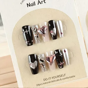 Set de uñas postizas negras y plateadas con diamantes de imitación y corazón rosa.