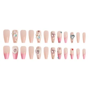 Set de uñas postizas ataúd largo, degradado rosa nude francés con dijes 3D y brillantes.