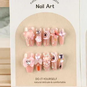Faux ongles roses avec nœuds 3D, cœurs et strass, ongles artificiels élégants pour les femmes.