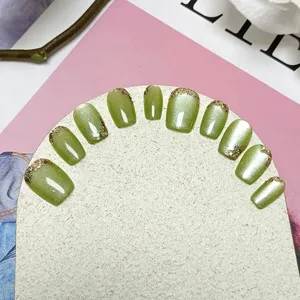 Uñas postizas de ojo de gato verde set de uñas cortas hechas a mano con purpurina dorada