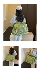 Detailed view of large capacity polka dot travel duffel bag showing model wearing angles.