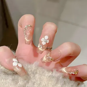Uñas postizas hechas a mano con flores blancas 3D, efecto ojo de gato y diamantes brillantes.