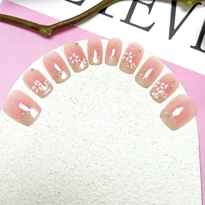 Vista detallada de unas postizas ojo de gato 3D con perlas y flores para manicura.