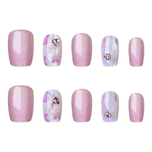 Uñas postizas cat-eye rosas con estampados florales y pedrería brillante. Set elegante.