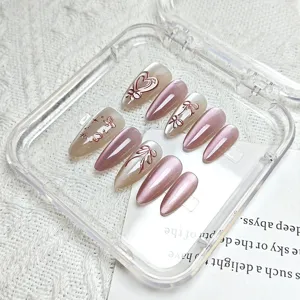 Handmade 3D almond press-on nails detail showing cat-eye effect and cute bow design.