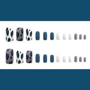 Vista detallada de 24 uñas postizas de los pies con estampado de leopardo azul y blanco.