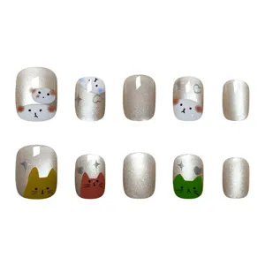 Detalles en primer plano de uñas postizas con gel ojo de gato y lindos diseños de gatitos.
