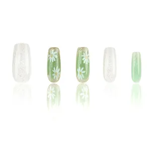 Uñas postizas hechas a mano, forma de bailarina con diseño de margaritas verdes y blanco con brillo.