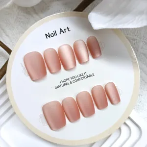 Matte velvet press-on nails detail closeup, trapezoid shape nude pink handmade fake nail art.