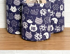 Detailed shot of Japanese style navy canvas lunch bag with cute cat print and bucket shape.