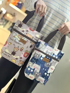 Waterproof cute cartoon canvas handbag with zipper pocket and sturdy brown handles for daily use.