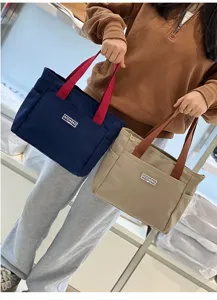Color-block canvas tote bag for daily commute, spacious handbag and stylish lunch storage.