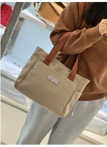 Casual contrast color tote bag for women, commuter handbag with multiple pockets and sturdy handles.