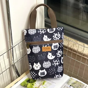 Black and white cute cat print waterproof handbag tote bag with brown handle for daily use.