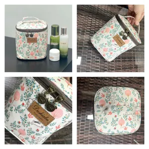 Detailed view of cosmetic bag with cute rabbit pattern, brown leather tag and bear zippers.