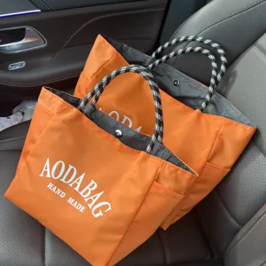 New minimalist large capacity orange tote bag with black white rope handles for women commuting