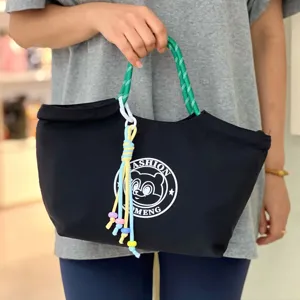 Waterproof black lunch handbag with green rope handles and cute cartoon bear print for daily use.