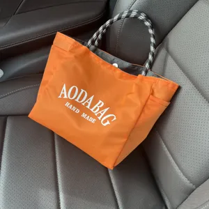 Orange minimalist large capacity tote bag for women, casual commuter shoulder handbag.