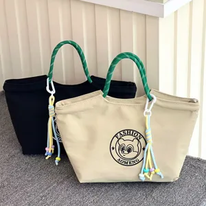 Waterproof canvas lunch tote bag with green rope handle and stylish beaded tassel charm for daily.