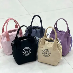 Waterproof insulated lunch bag with drawstring closure, portable handbag for daily use.