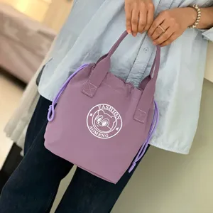 Purple waterproof canvas bucket bag with drawstring closure, portable lunch handbag for daily commute.