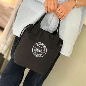 Black waterproof drawstring handbag bento lunch box thermal bucket bag for women commuter use.