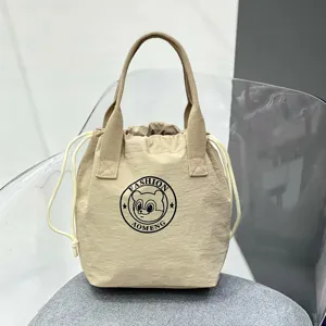 Waterproof canvas drawstring lunch bag, portable bucket handbag, casual commuter bento bag.