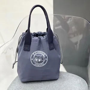 Grey waterproof drawstring lunch bag with double handles, portable bento tote for daily commute.