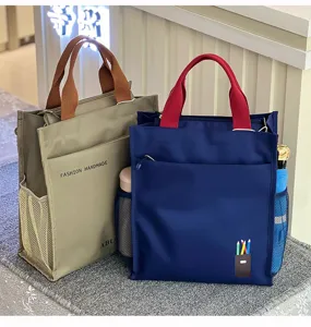 Detailed view of color-blocked multi-layer canvas tote bag featuring spacious compartments.