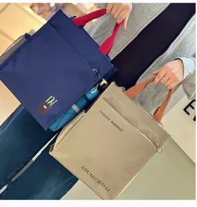 Multi-layer canvas tote bag detail view, student file handbag with multiple pockets.