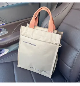 Thickened color-contrast commuter tote bag with multi-layer pockets and durable orange handles.