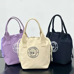 Close-up detail of waterproof canvas drawstring lunch bag with cute bear logo print.