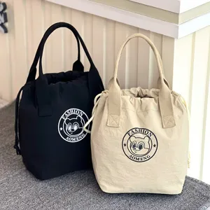 Waterproof canvas bucket bag with drawstring closure, portable handbag and cute bear logo.