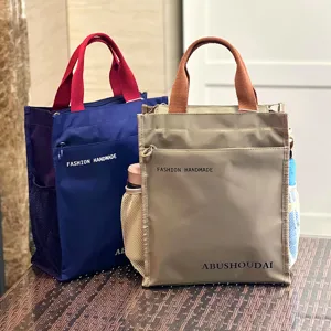 Detail view of the multi-layer thickened tote bag showing side mesh pockets and front zip compartment.