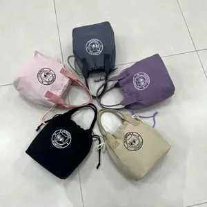 Detailed view of multi-color waterproof canvas bento lunch bags with cute bear print.