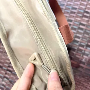 Detail shot of the stylish color-block handbag showing durable nylon material and zipper.